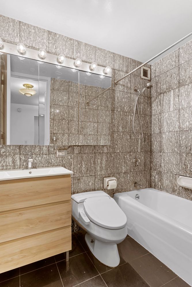 1 Irving Place, Unit U7BC Manhattan, NY 10003 - Photo 6 of 20 a bathroom with a toilet a sink and bathtub