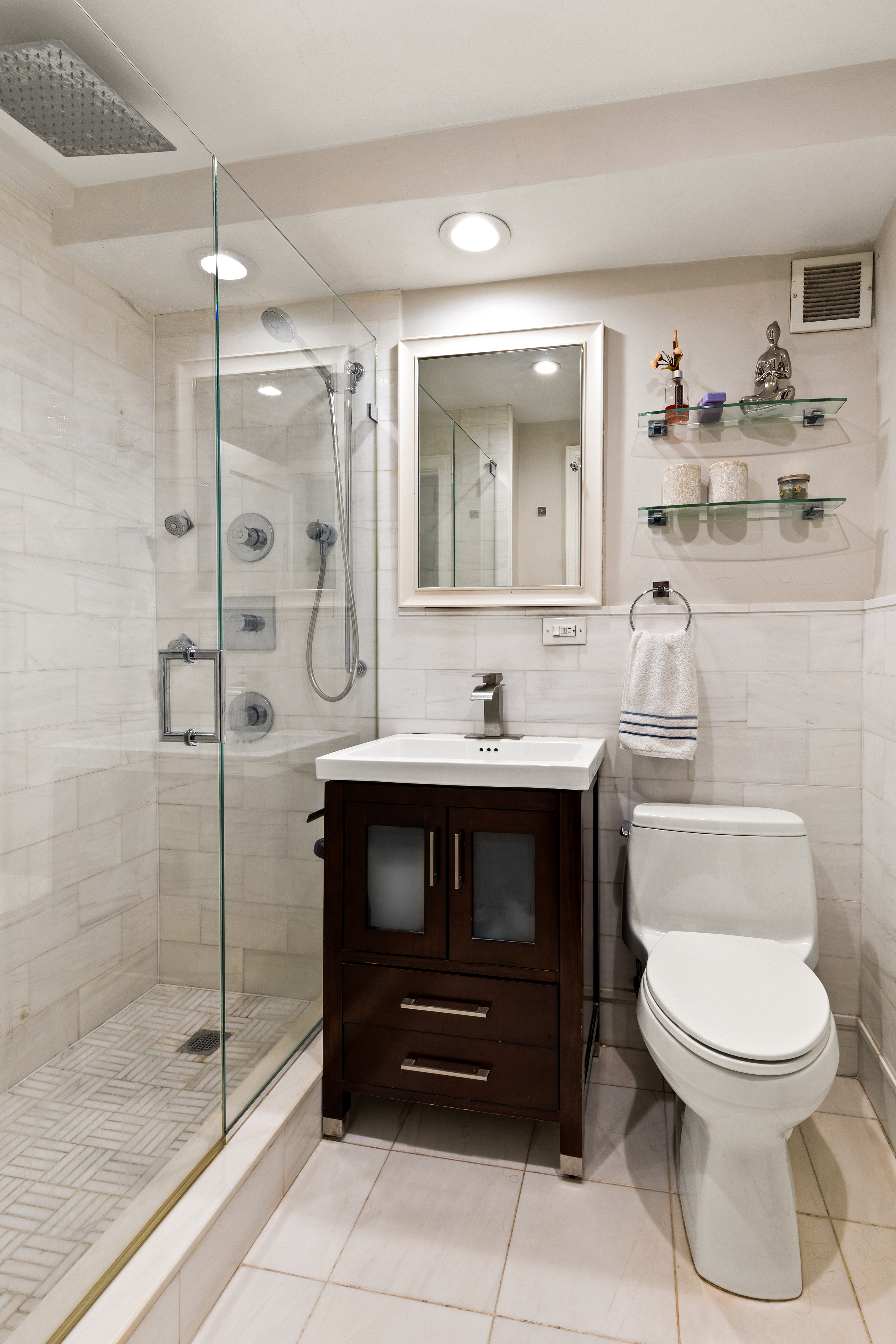 310 East 70th Street, Unit 6A Manhattan, NY 10021 - Photo 4 of 9 a bathroom with a toilet sink and shower
