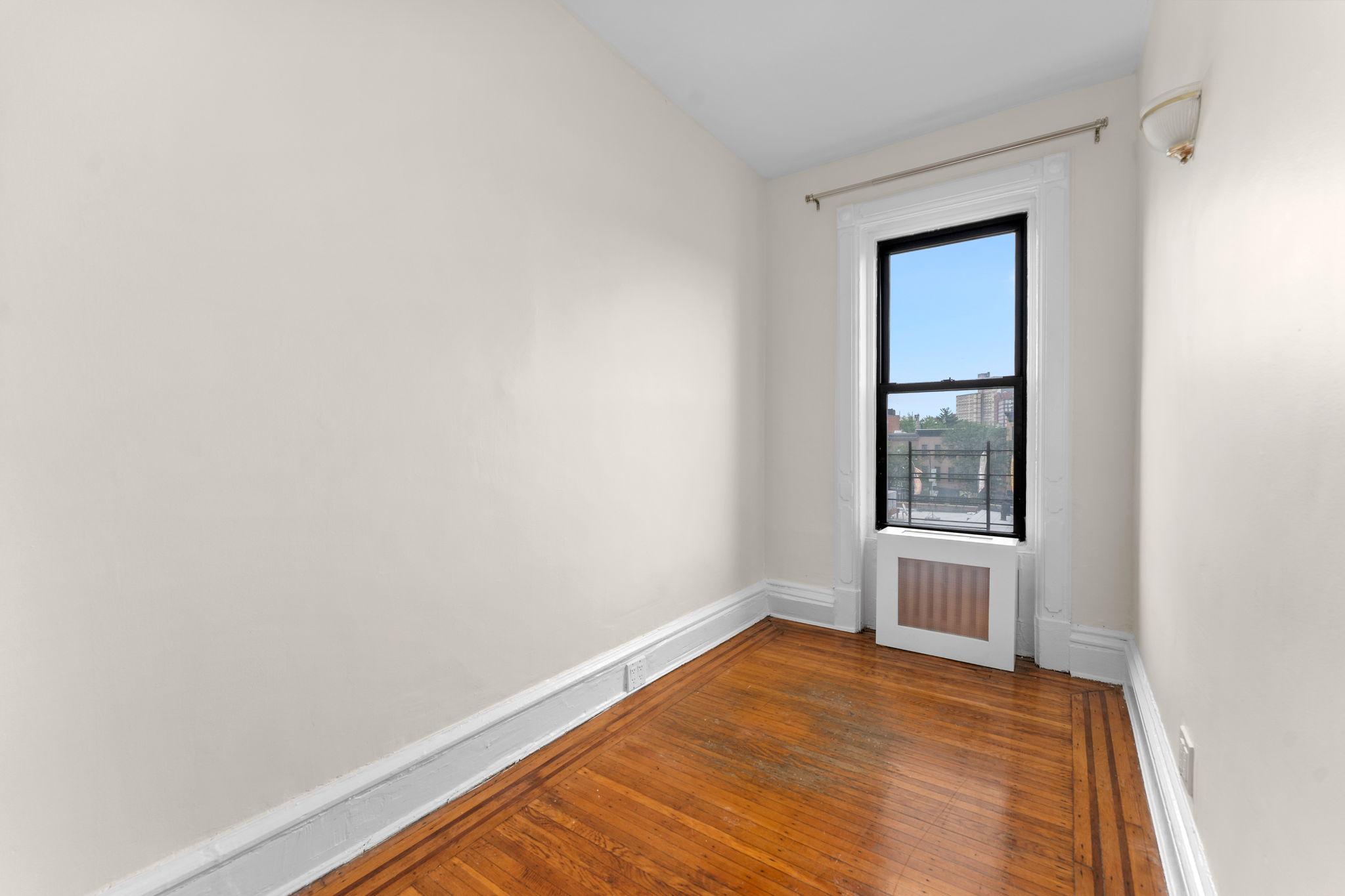 149 Sterling Place, Unit 4 Brooklyn, NY 11217 - Photo 4 of 9 a view of empty room with wooden floor and fan