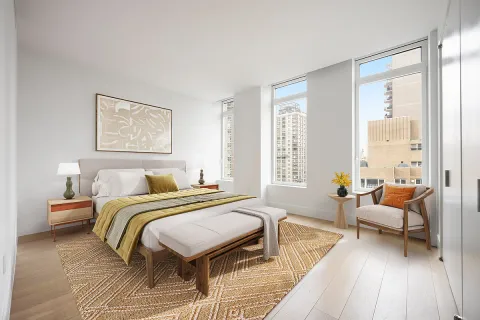 a spacious bedroom with a bed and a couch