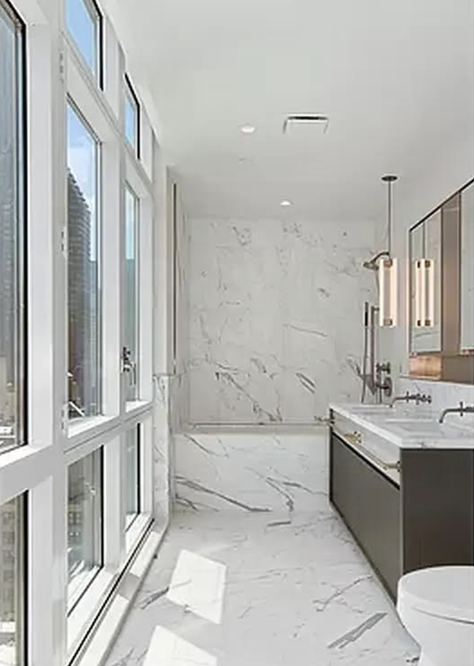 305 East 51st Street, Unit 14F Manhattan, NY 10022 - Photo 9 of 19 a bathroom with a tub sink and mirror