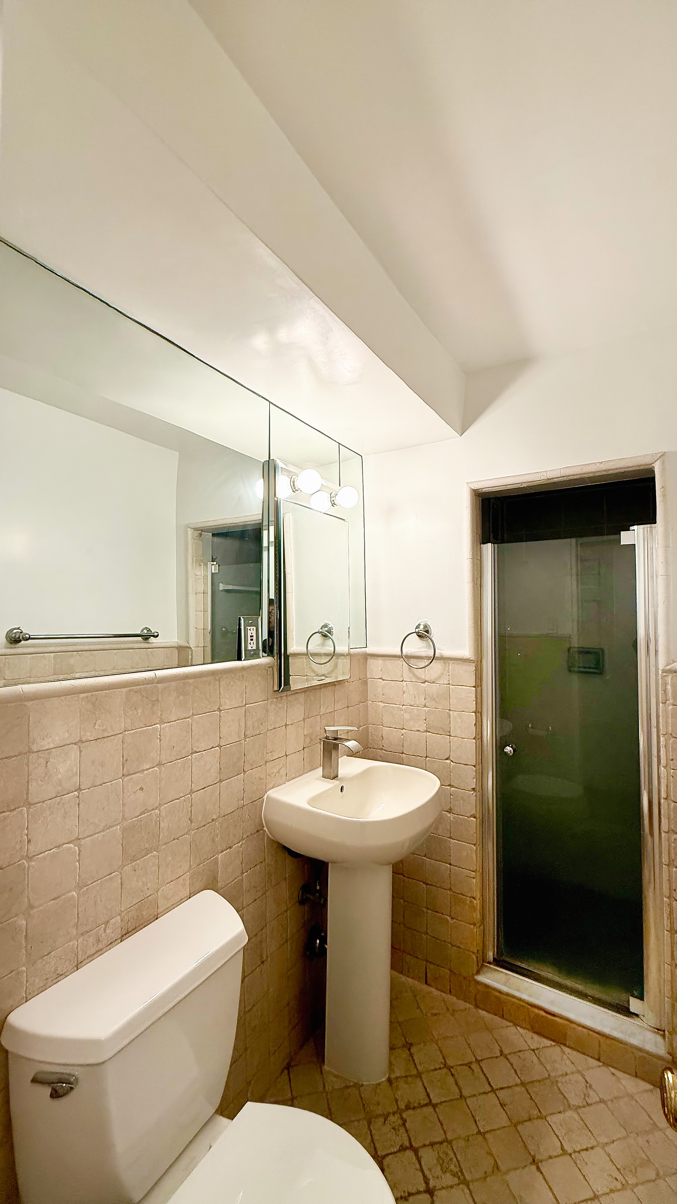 420 East 64th Street, Unit W4D Manhattan, NY 10065 - Photo 11 of 19 a bathroom with a toilet sink and mirror