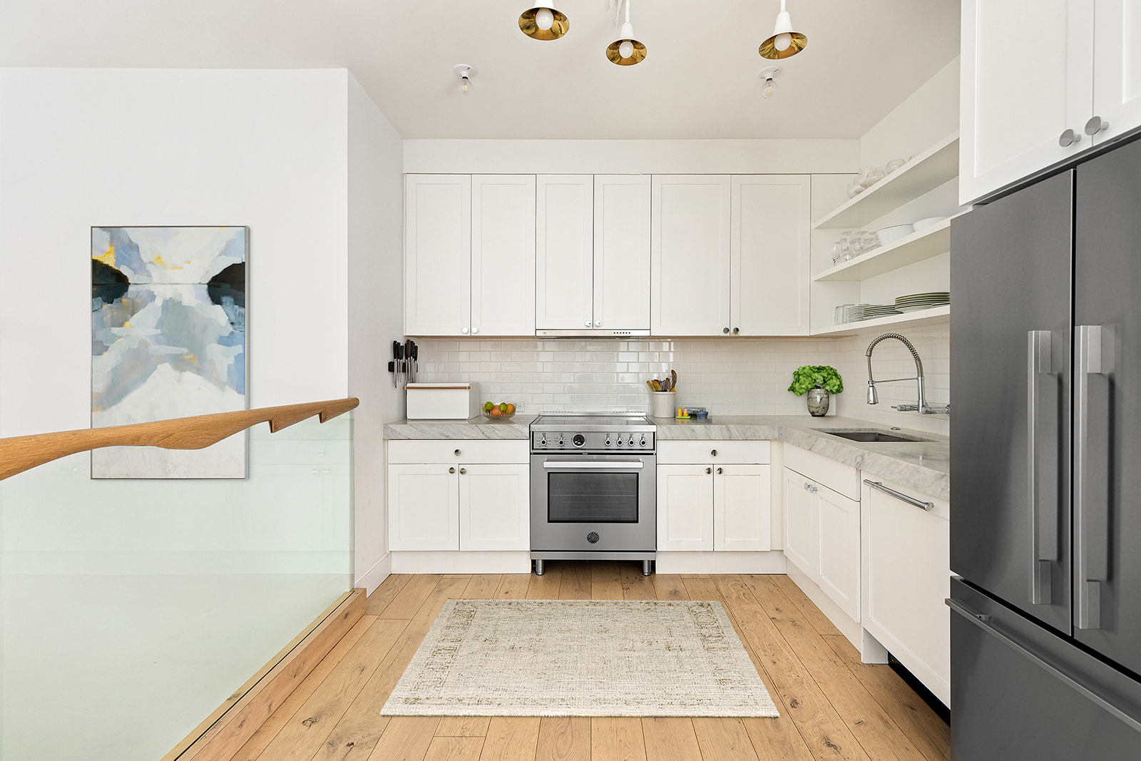 719 6th Avenue, Unit 1 Brooklyn, NY 11215 - Photo 2 of 10 a kitchen with granite countertop a sink stainless steel appliances and white cabinets