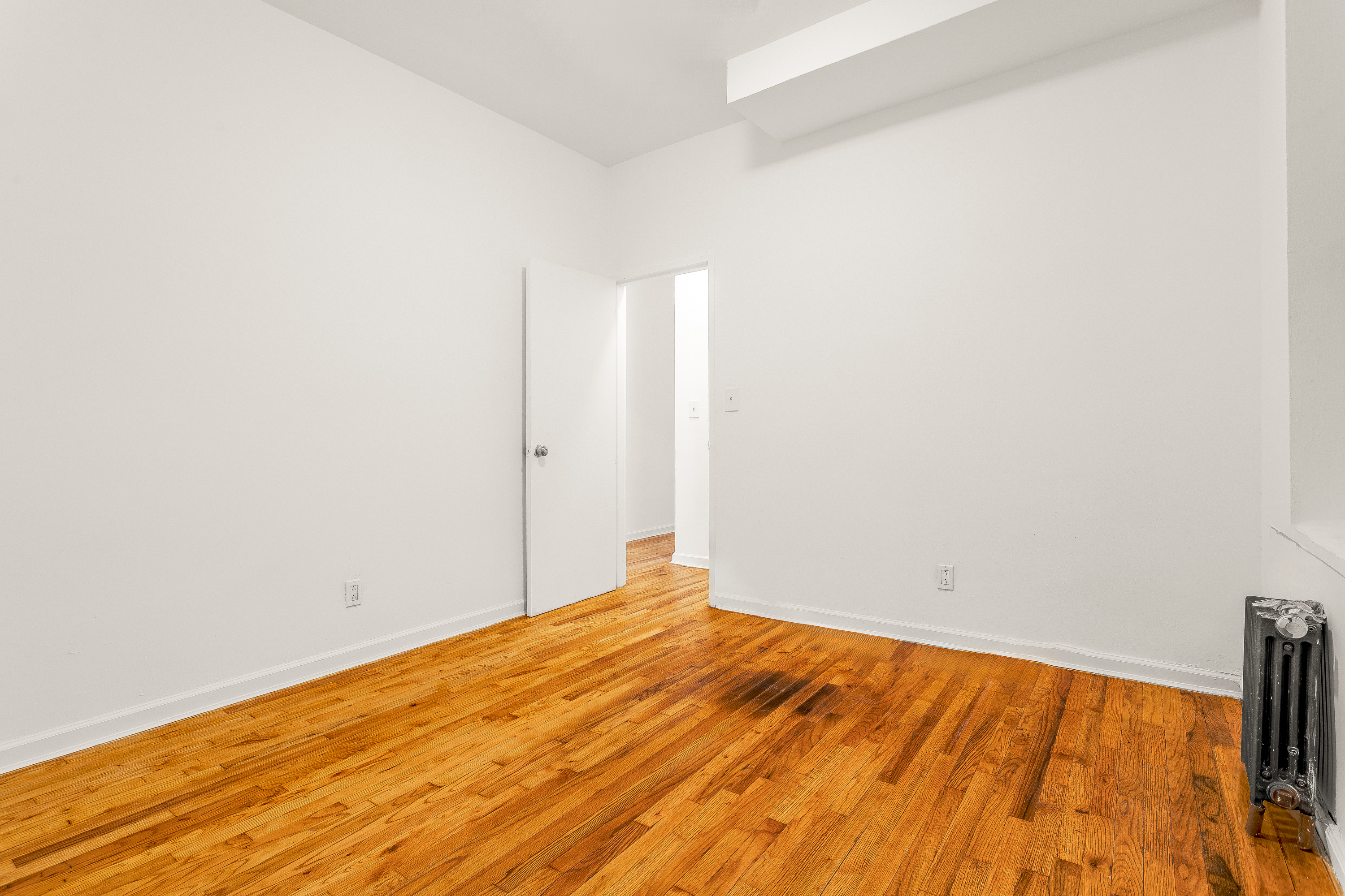 157 West 123rd Street, Unit 2A Manhattan, NY 10027 - Photo 12 of 16 a view of empty room with wooden floor