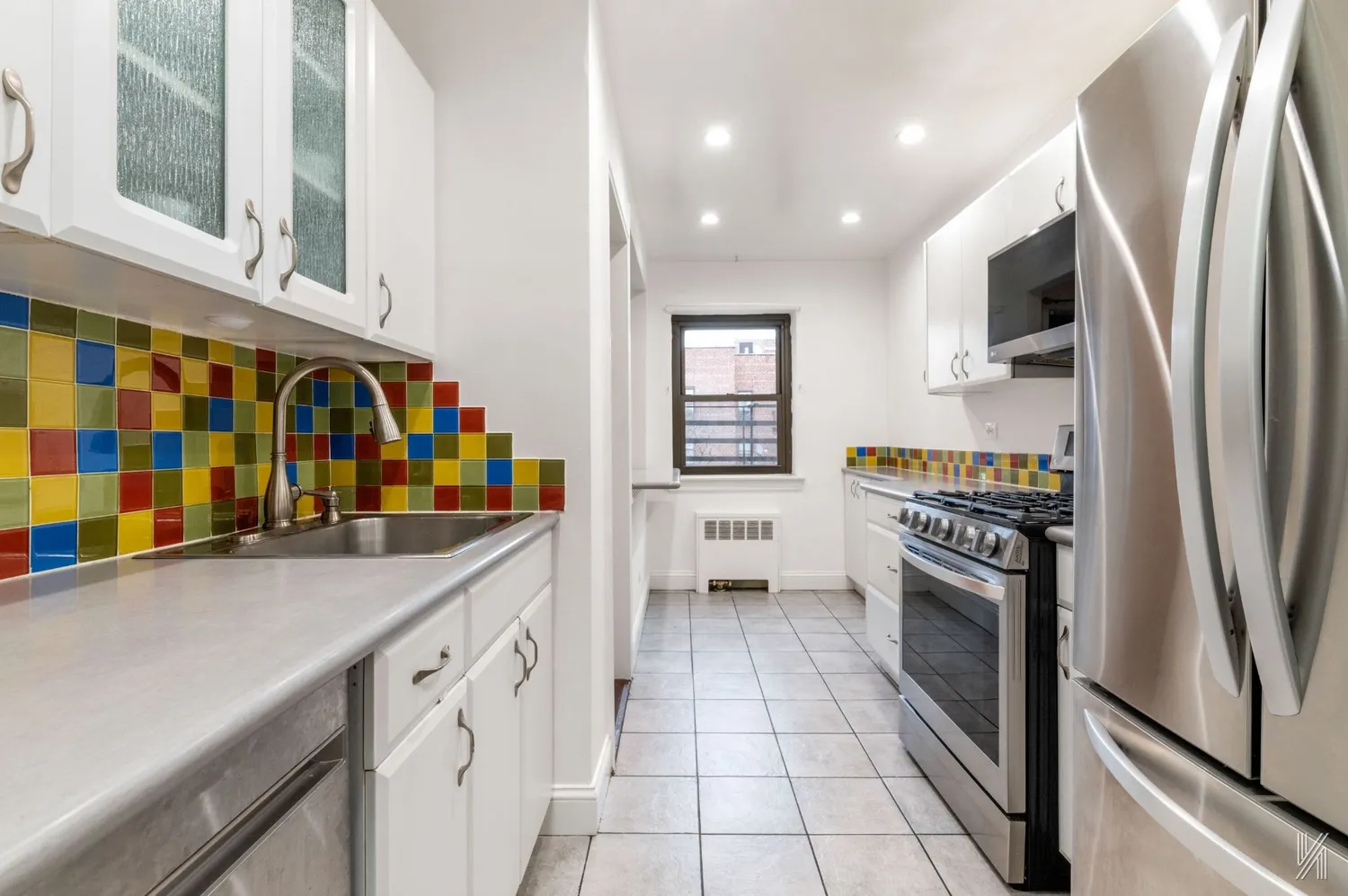 a kitchen with stainless steel appliances granite countertop a refrigerator and a stove