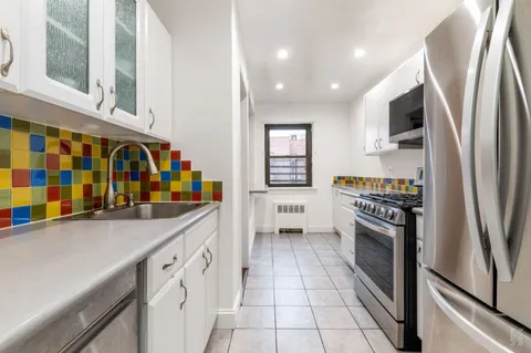 a kitchen with stainless steel appliances granite countertop a refrigerator and a stove
