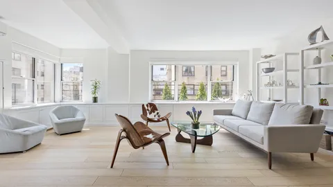 a living room with furniture and large windows