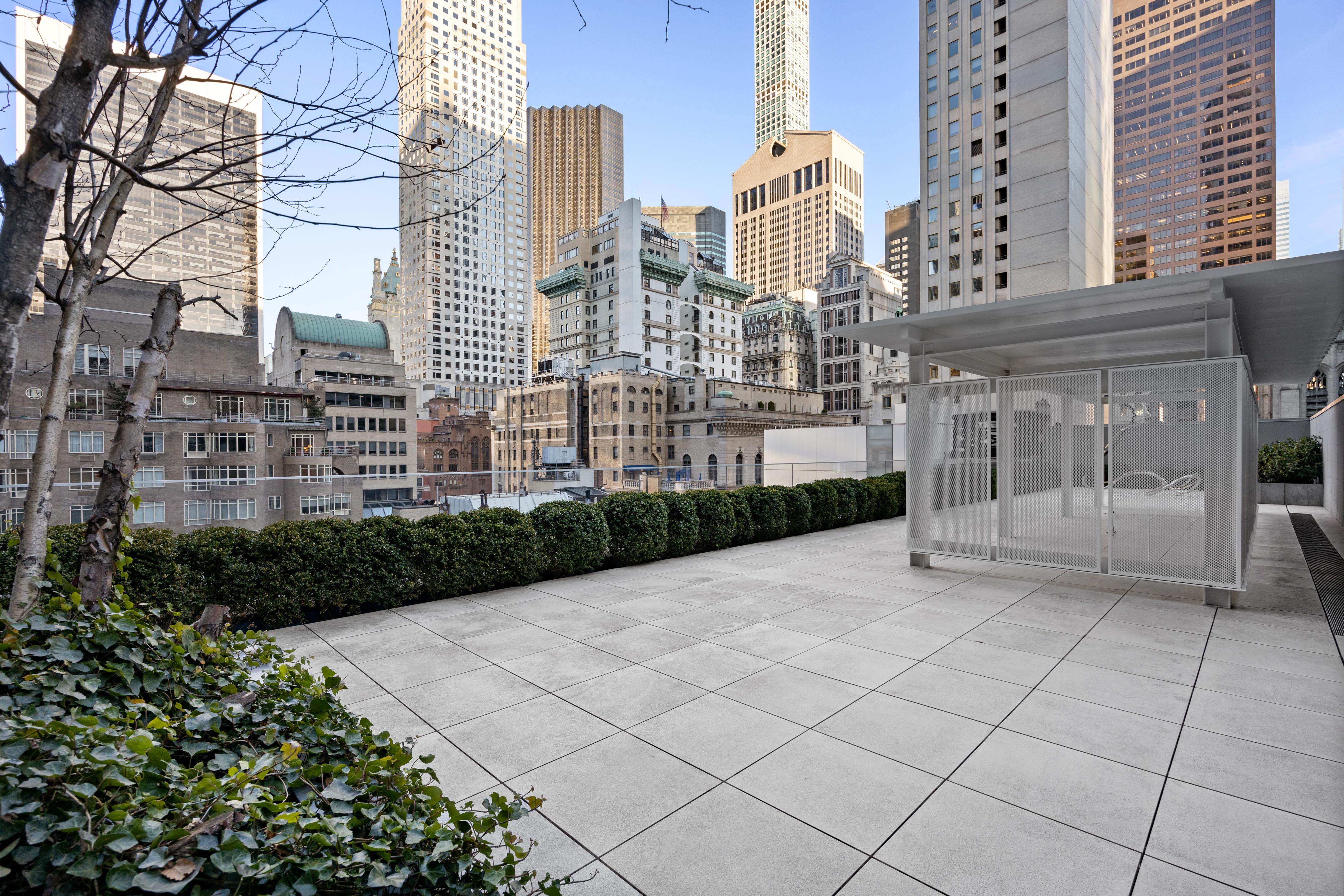 15 West 53rd Street, Unit 10H Manhattan, NY 10019 - Photo 9 of 11 a view of a building with garden