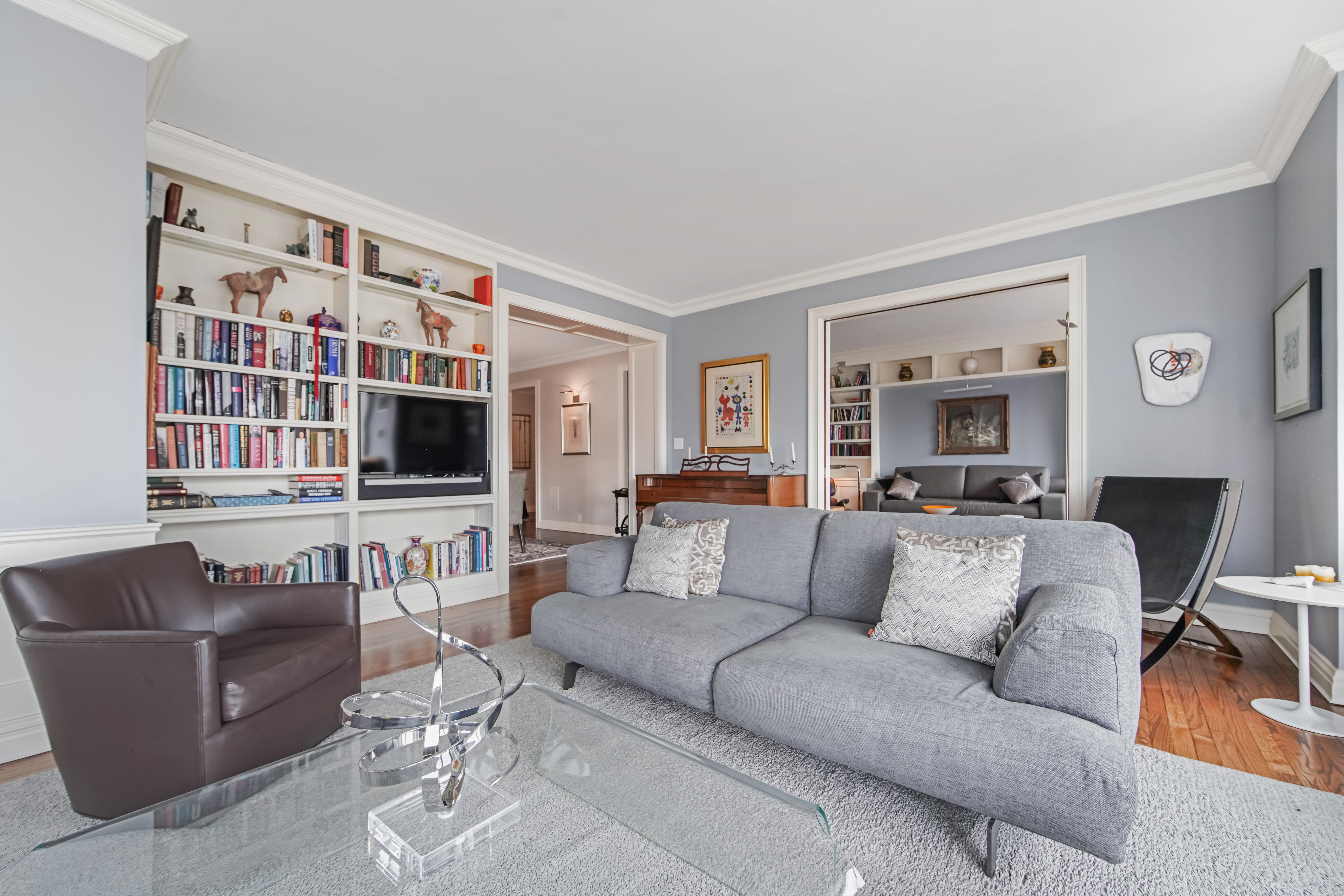 425 East 58th Street, Unit 29C Manhattan, NY 10022 - Photo 3 of 9 a living room with furniture and a flat screen tv