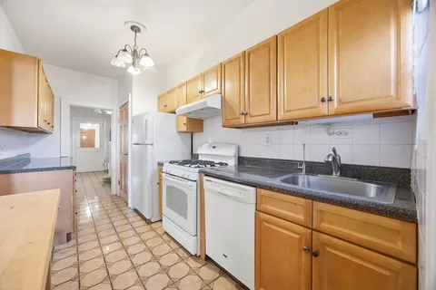 a kitchen with stainless steel appliances granite countertop a sink a stove and cabinets
