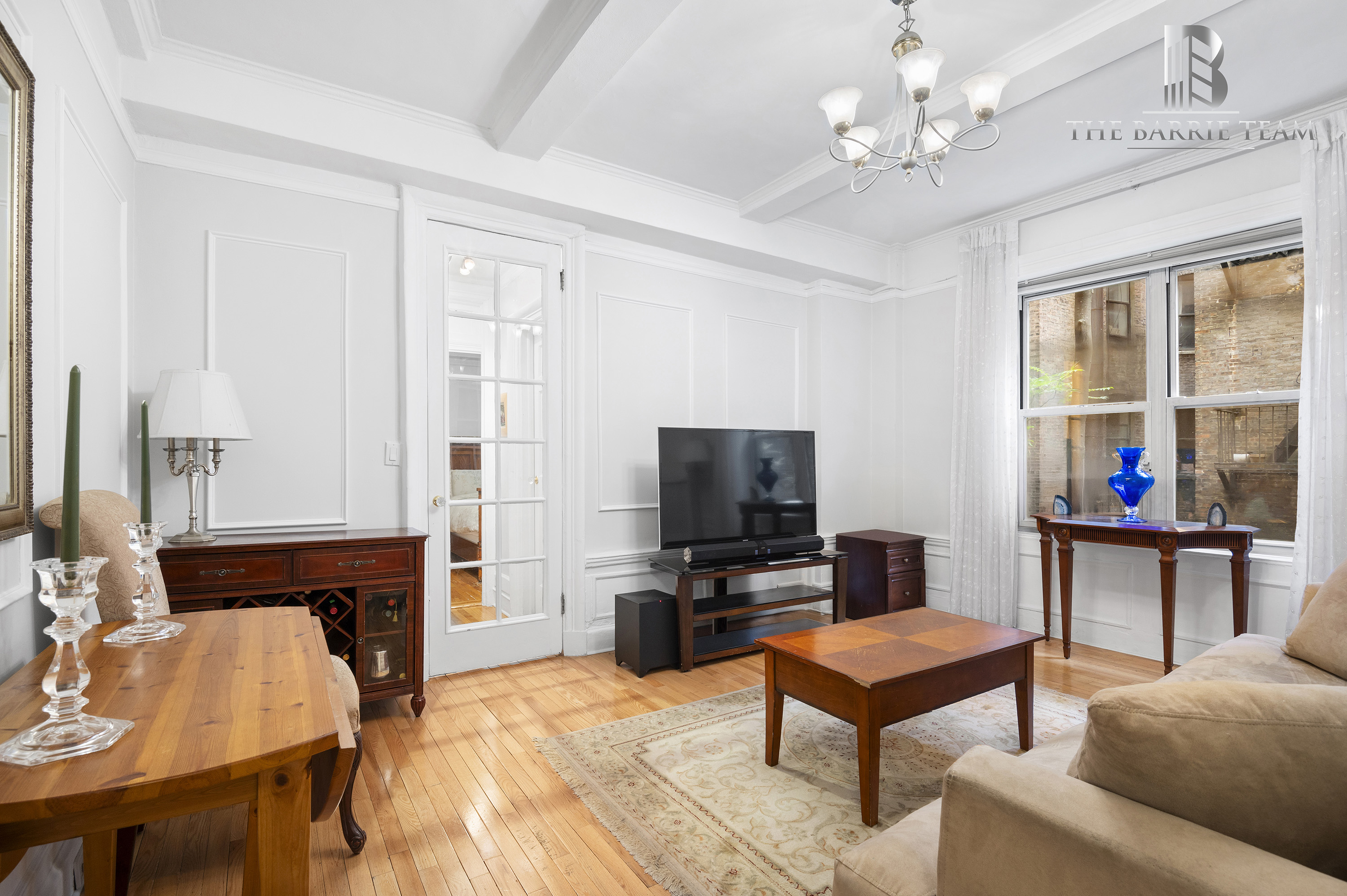 203 West 81st Street, Unit 3E Manhattan, NY 10024 - Photo 1 of 6 a living room with furniture and a flat screen tv