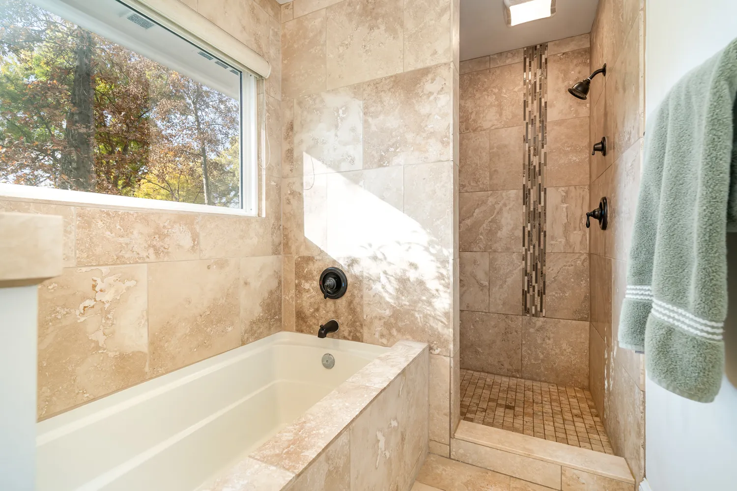 a bathroom with a tub a sink and a shower