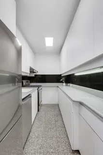 a kitchen with a sink and white cabinets