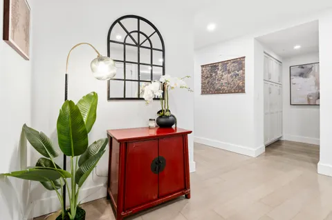 a view of entryway with paintings on the wall