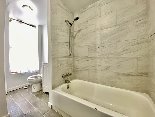 591 Vanderbilt Avenue, Unit 4 Brooklyn, NY 11238 - Photo 10 of 10 a bathroom with a sink a toilet and a bathtub