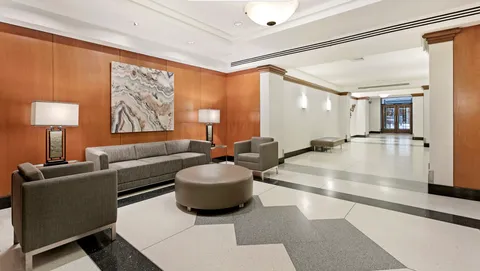 a living room with furniture and a lamp