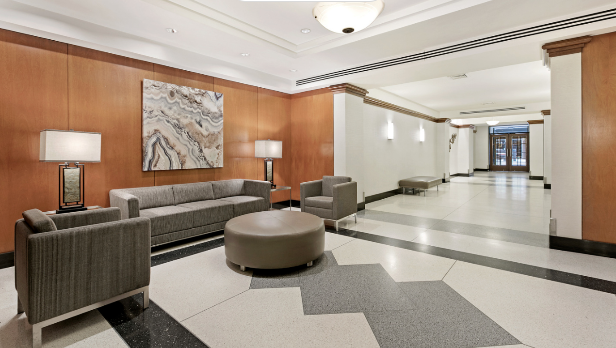 10 West 15th Street, Unit 414 Manhattan, NY 10011 - Photo 12 of 16 a living room with furniture and a lamp