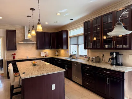 a kitchen that has a sink and cabinets in it