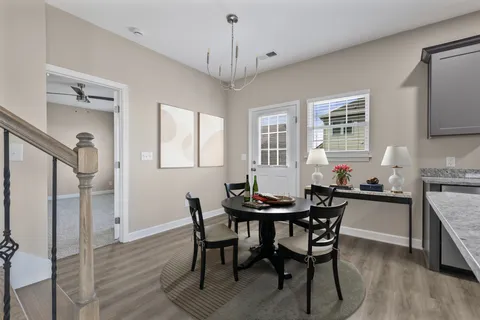 a view of a dining room with furniture and wooden floor