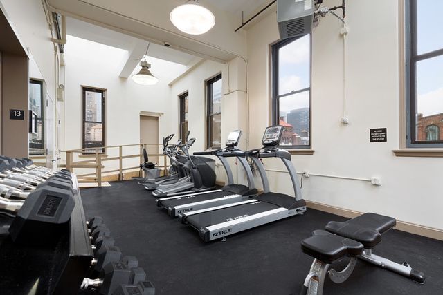 11 East 36th Street, Unit 306 Manhattan, NY 10016 - Photo 7 of 11 a room with gym equipment and a large window