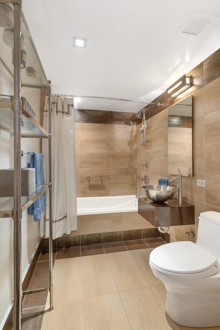 2-17 51st Avenue, Unit 606 Queens, NY 11101 - Photo 10 of 18 a bathroom with a toilet and a shower