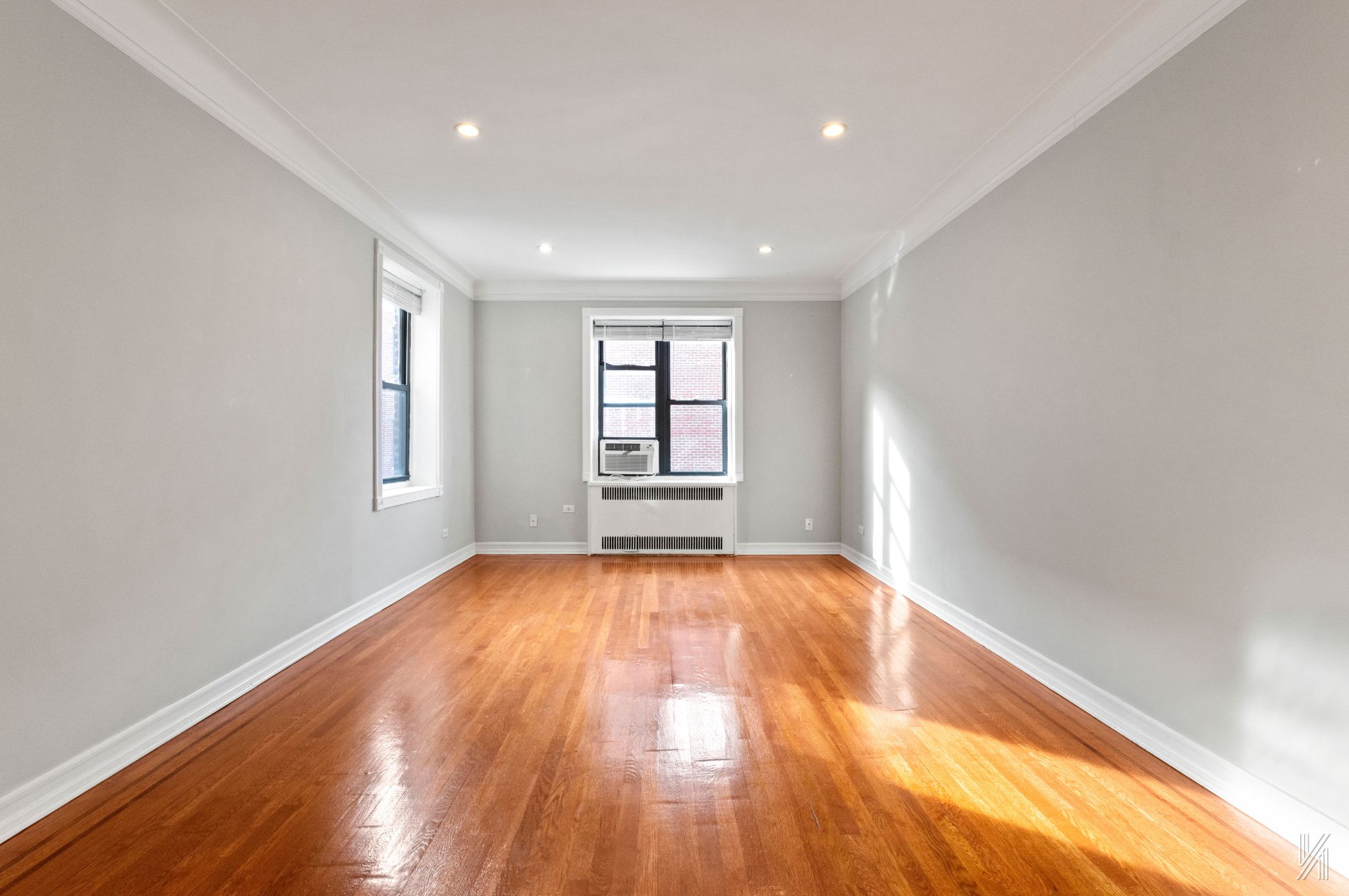 25-40 31st Avenue, Unit 6E Queens, NY 11106 - Photo 3 of 15 wooden floor in an empty room with a window