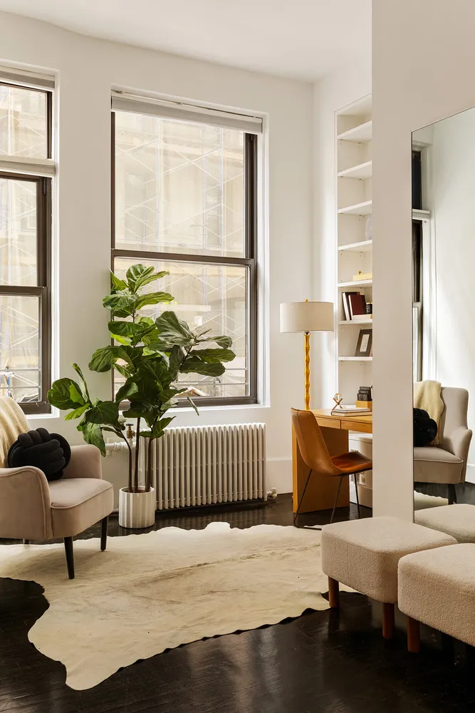 a bedroom with furniture and a window