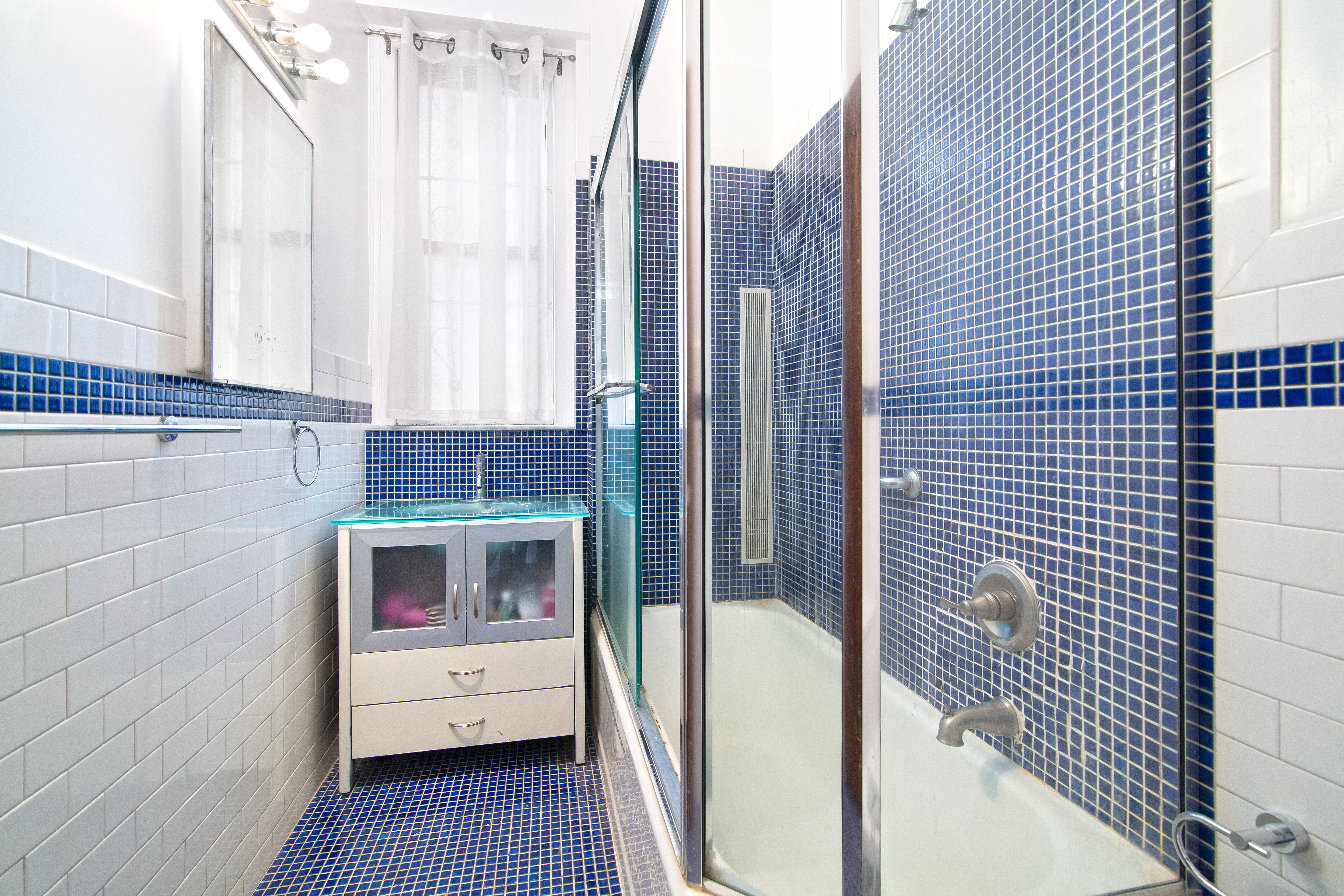 504 West 110th Street, Unit 8F Manhattan, NY 10025 - Photo 4 of 7 a view of a hallway with wooden floor and a fireplace