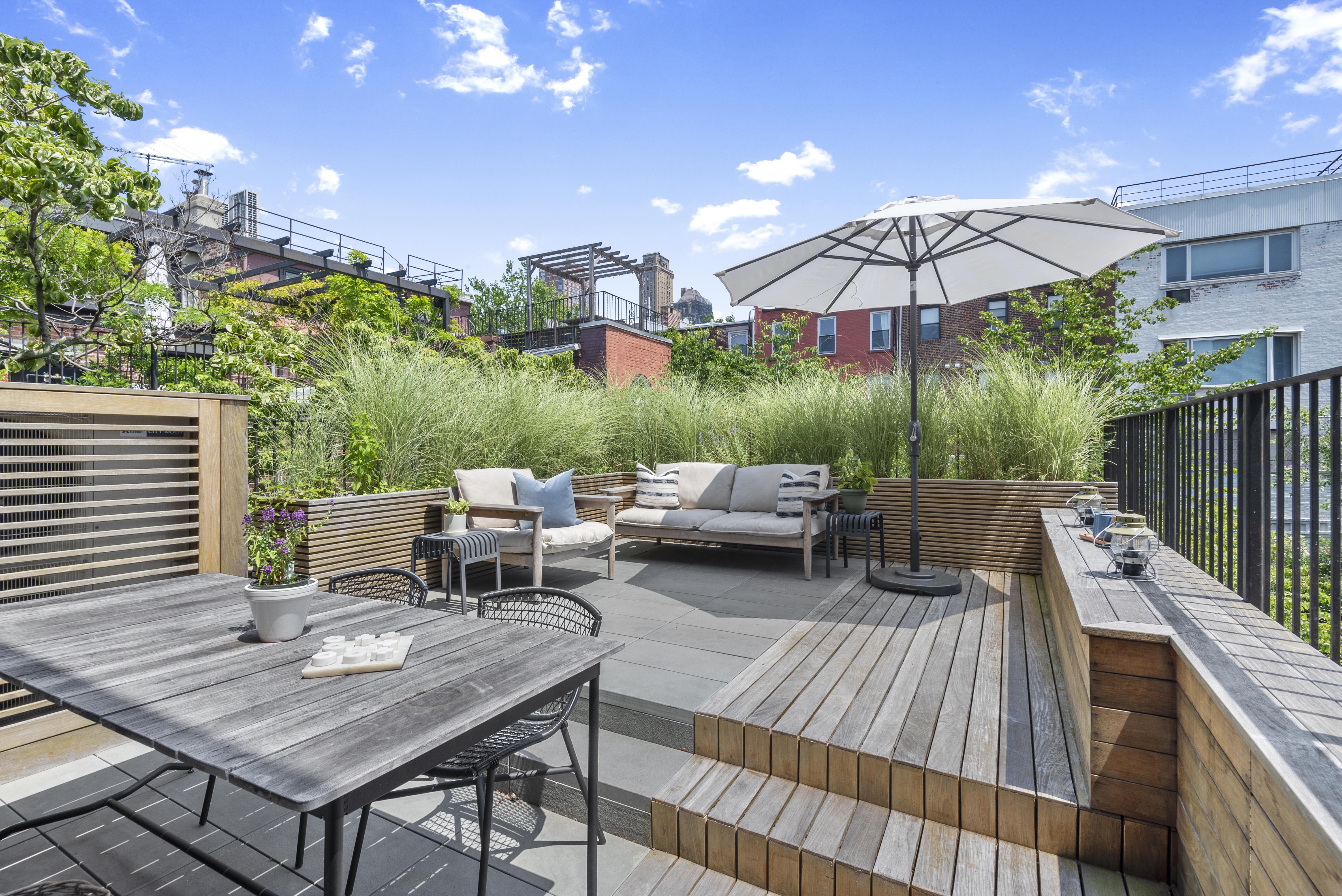 9 Garden Place, Unit 2 Brooklyn, NY 11201 - Photo 2 of 18 a patio with hardwood table and chairs