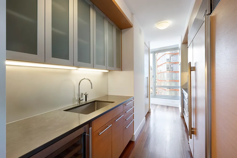 a kitchen with stainless steel appliances granite countertop a sink and a refrigerator