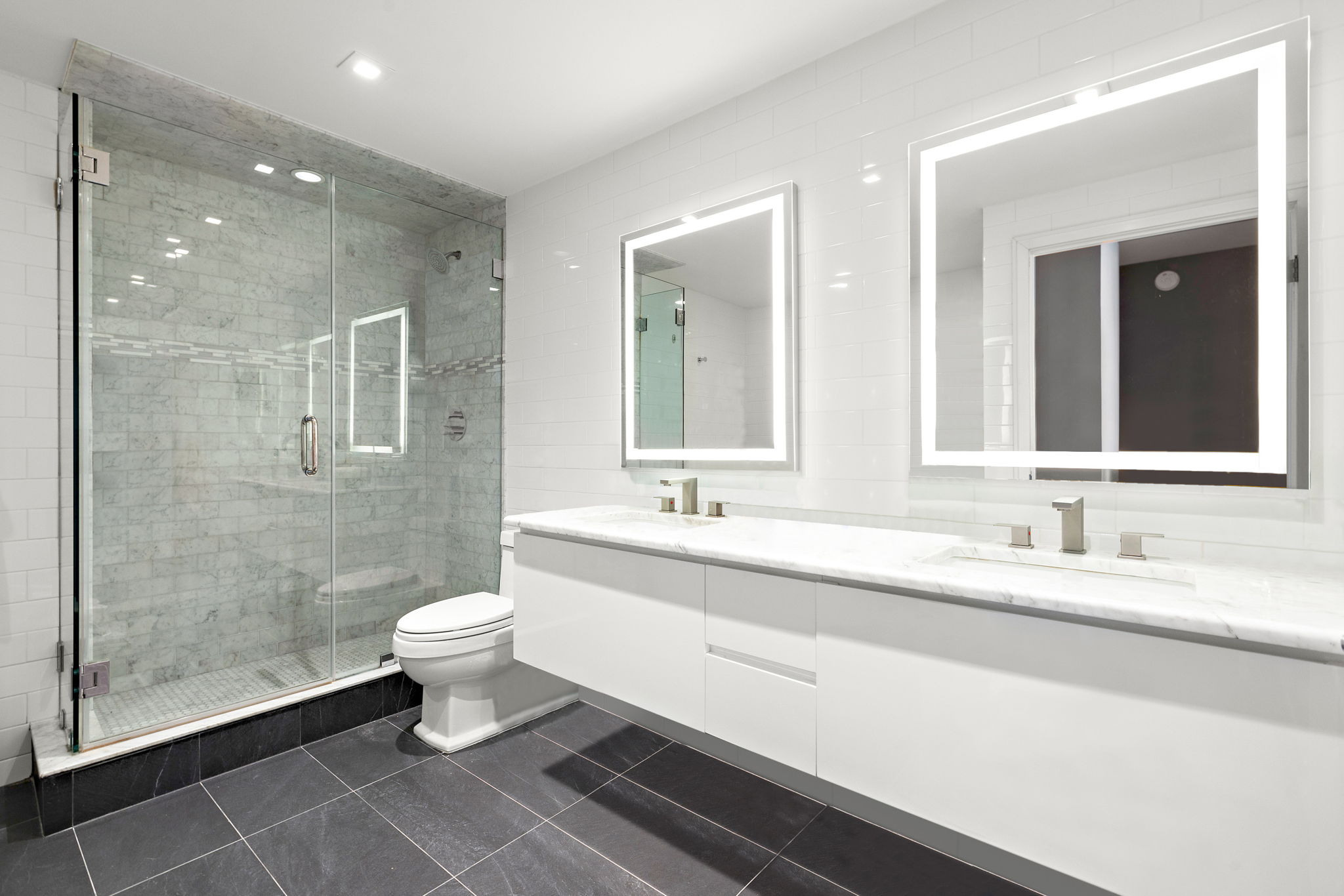 380 Mountain Road, Unit 1906 Union City, NJ 07087 - Photo 8 of 18 a bathroom with a double vanity sink toilet and a mirror