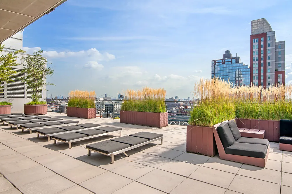 a view of a terrace with chairs and lounge chair