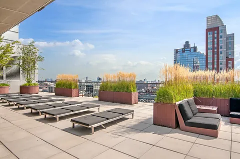 a view of a terrace with chairs and lounge chair