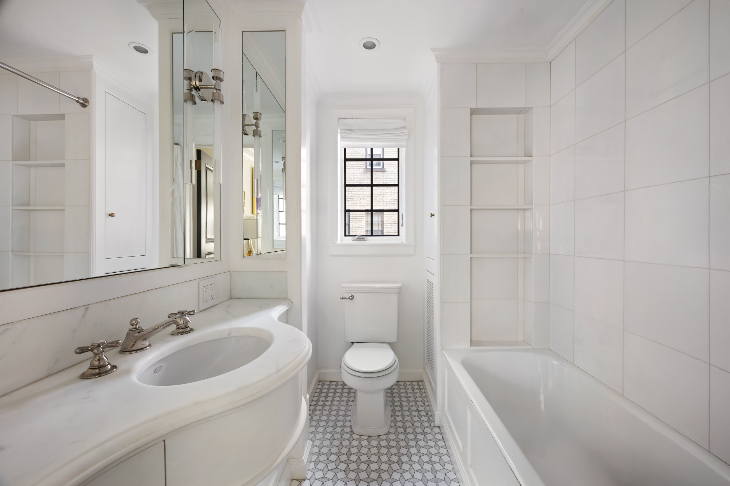 170 East 78th Street, Unit 8E Manhattan, NY 10075 - Photo 12 of 16 a bathroom with a sink a toilet and shower