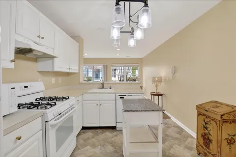 a kitchen with stainless steel appliances a stove oven and cabinets
