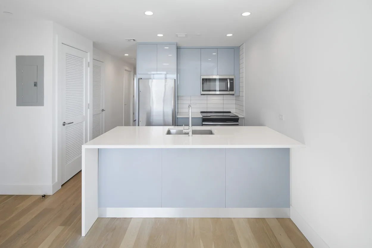 a kitchen with stainless steel appliances a refrigerator and a microwave