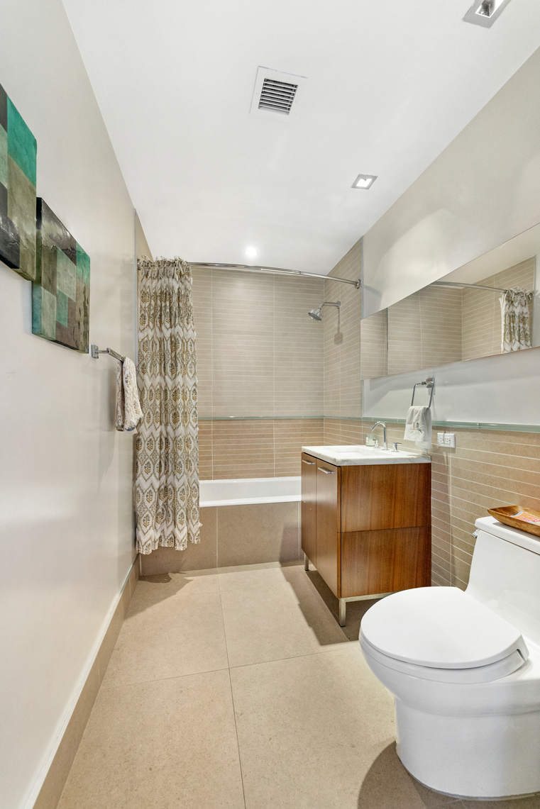 2-17 51st Avenue, Unit 606 Queens, NY 11101 - Photo 11 of 18 a bathroom with a sink toilet and shower