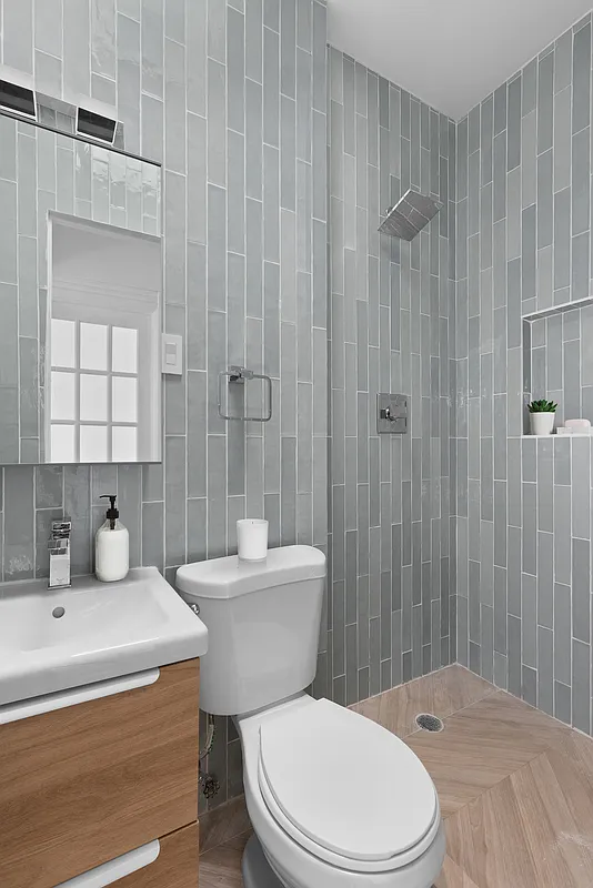 532 10th Street, Unit 1 Brooklyn, NY 11215 - Photo 5 of 6 a bathroom with a sink a toilet and shower