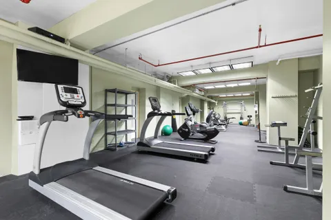 a room with gym equipment and a mirror
