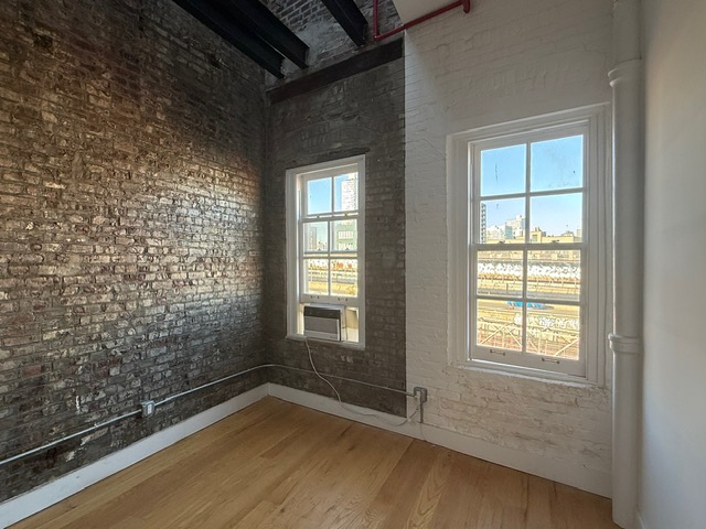 103 Broadway, Unit PH Brooklyn, NY 11249 - Photo 4 of 8 a view of an empty room with a window