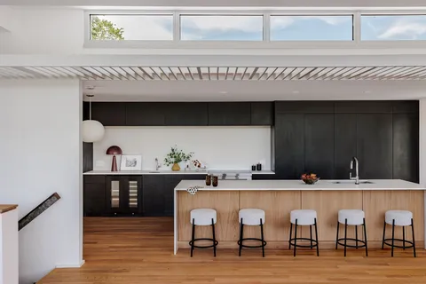a kitchen with a sink cabinets and stove top oven