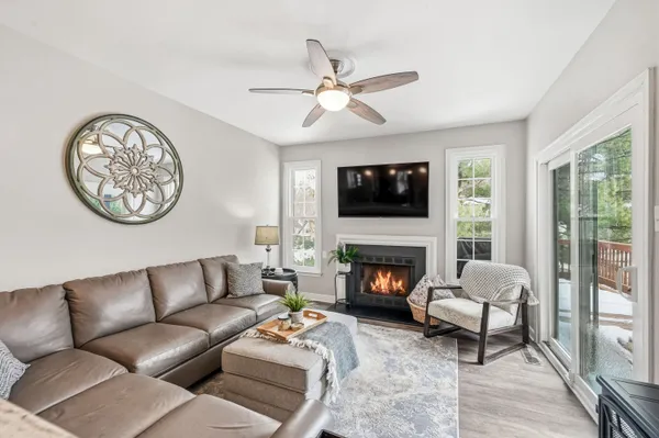 a living room with furniture a clock and a fireplace