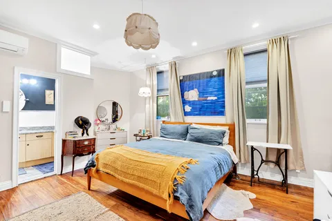 a bedroom with a bed a table and chair