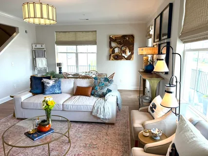 a living room with furniture and a chandelier