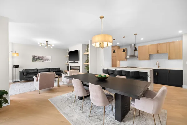 a kitchen with a dining table chairs and living room view