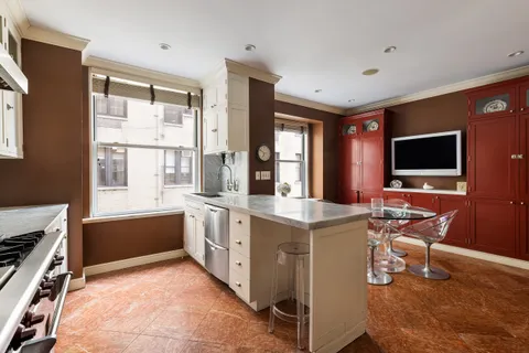 a kitchen with a stove a sink and a microwave