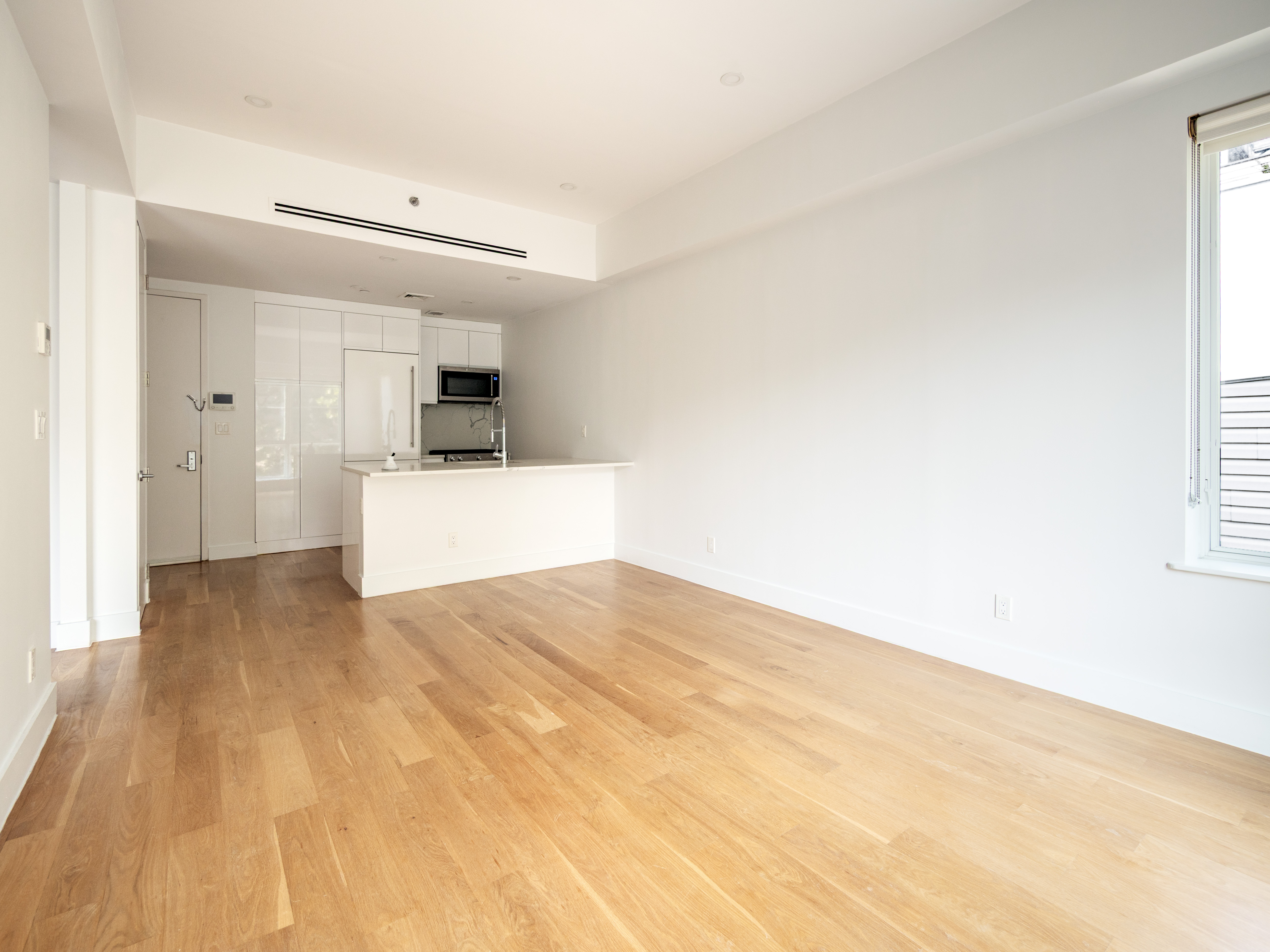 21 Powers Street, Unit 3A Brooklyn, NY 11211 - Photo 4 of 14 a view of a kitchen with a sink and a refrigerator