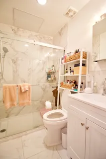 a bathroom with a toilet sink and shower