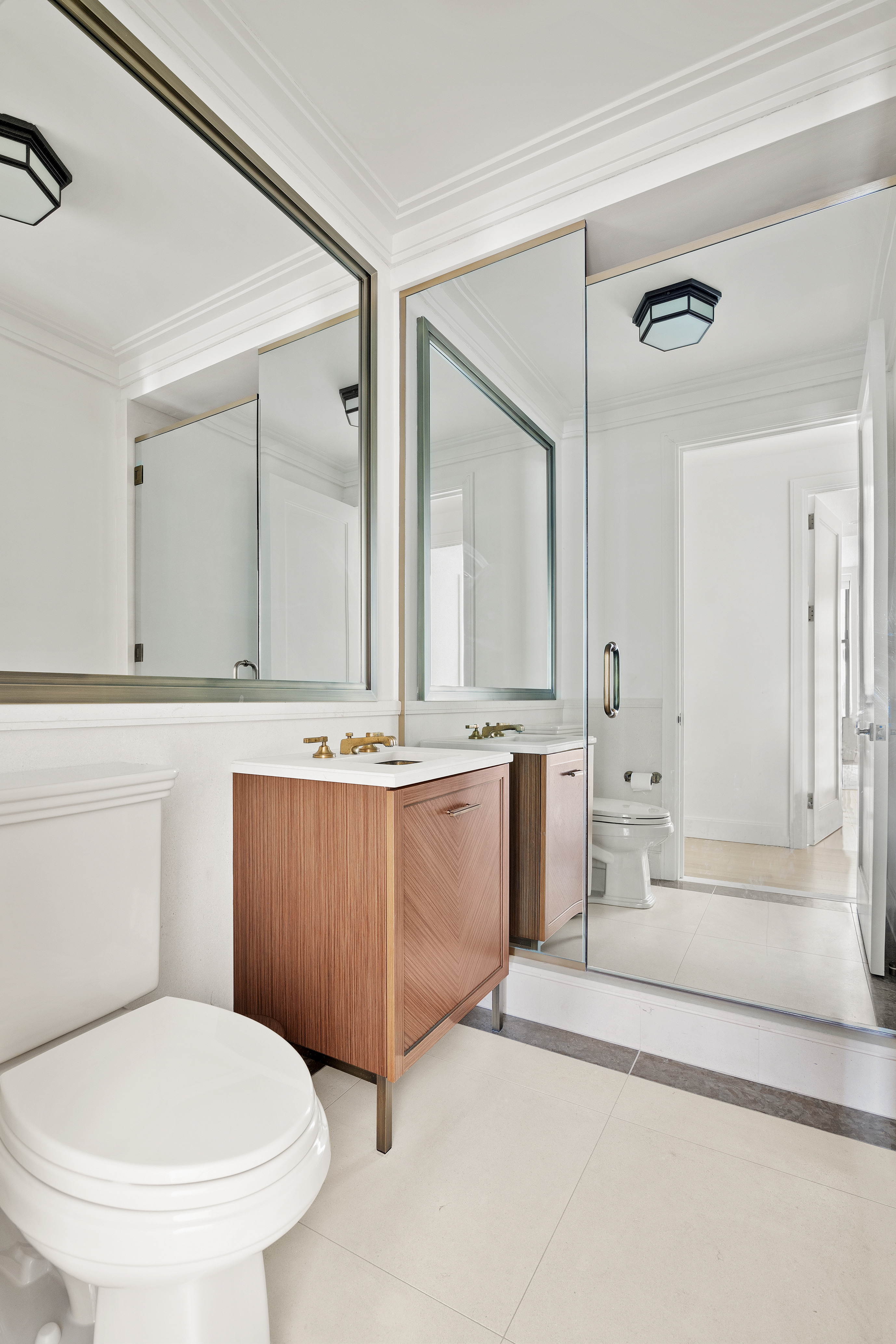 100 Barclay Street, Unit 16D Manhattan, NY 10007 - Photo 10 of 14 a bathroom with a granite countertop sink mirror vanity and toilet