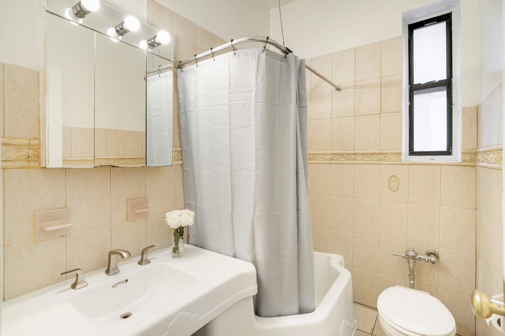 668 Riverside Drive, Unit 3G Manhattan, NY 10031 - Photo 4 of 6 a bathroom with a sink a toilet a mirror and shower